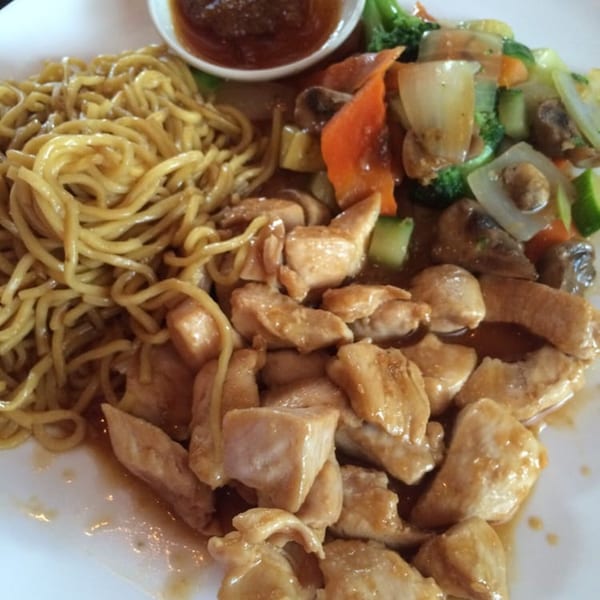 Osaki Japanese Cuisine's chicken teriyaki with noodles, mixed vegetables, and a side of sauce.